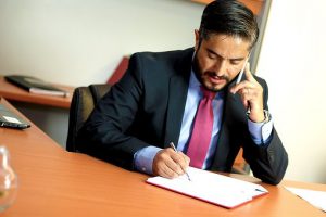 A man in the office helping you with buying an apartment in Brooklyn.