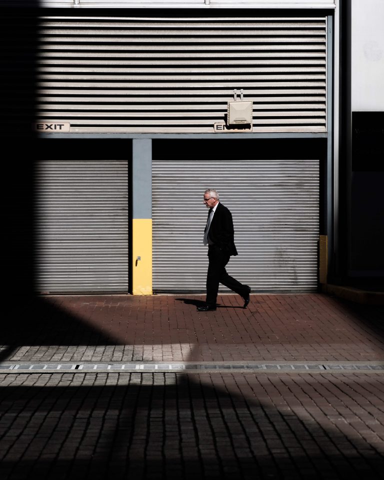 A man walking in front of storage unit door